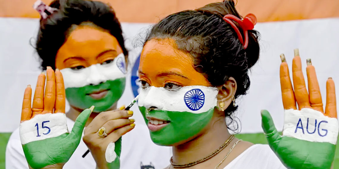 نادیہ میں یوم آزادی کی تقریبات کی تیاری میں ایک نوجوان خاتون اپنے چہرے کو ترنگوں سے پینٹ کر رہی ہے۔